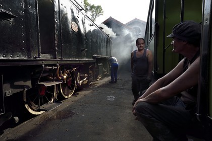 France, Alpes-Maritimes, Puget Theniers, steam engine warming up, Luc Cabouret and Frederic Laugier (right) volunteers of G.E.C.P. that restores and operates the Train des Pignes