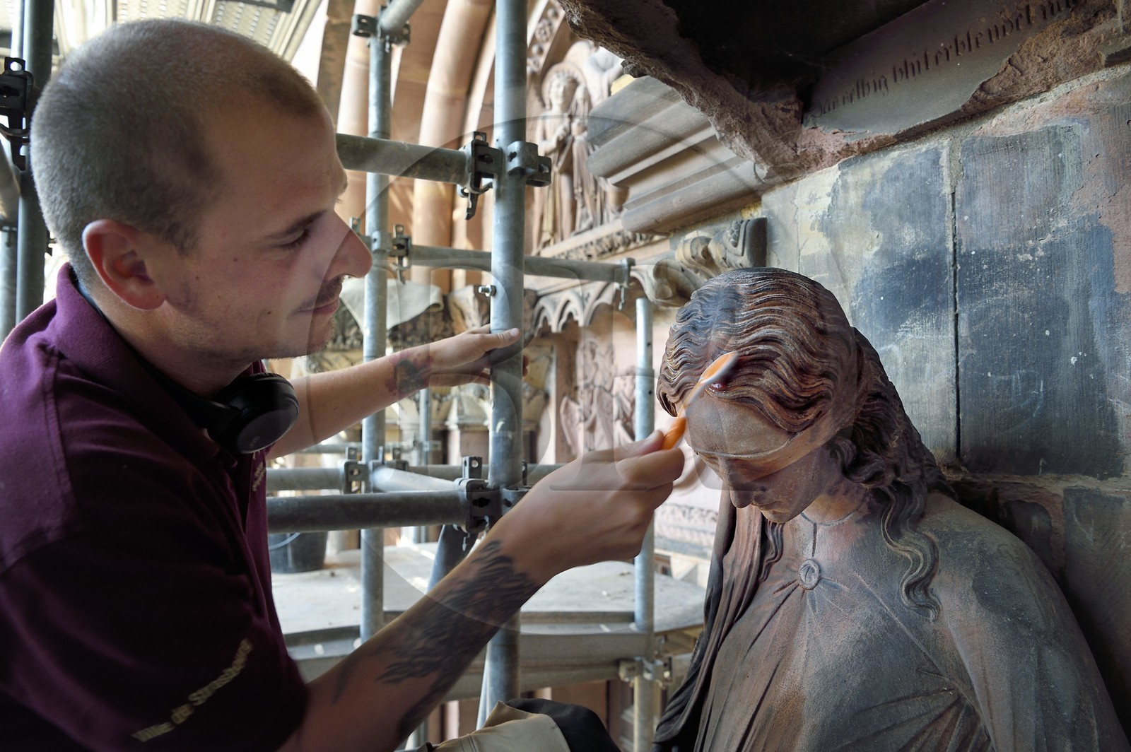 France, Bas Rhin, Strasbourg, old town listed as World Heritage by UNESCO, Notre Dame Cathedral, Judgment Day Portal Restoration Site, cleaning of the so-called Synagogue sculpture with a toothbrush by a stonemason companion