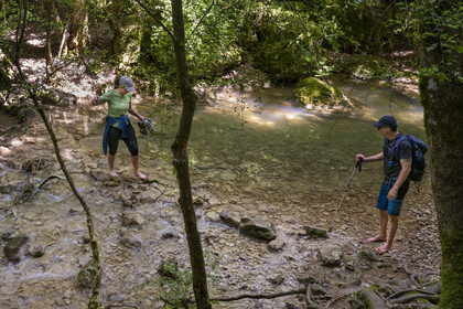 France, Vaucluse, Mont Ventoux Regional Natural Park, Monieux, Gorges de La Nesque, hikers crossing the Nesque river by ford