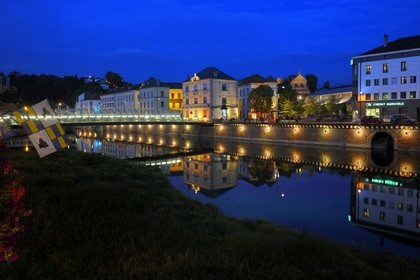 France, Vosges, Epinal, quai Jules Ferry along the Moselle River and the Basilica of St. Maurice in the background