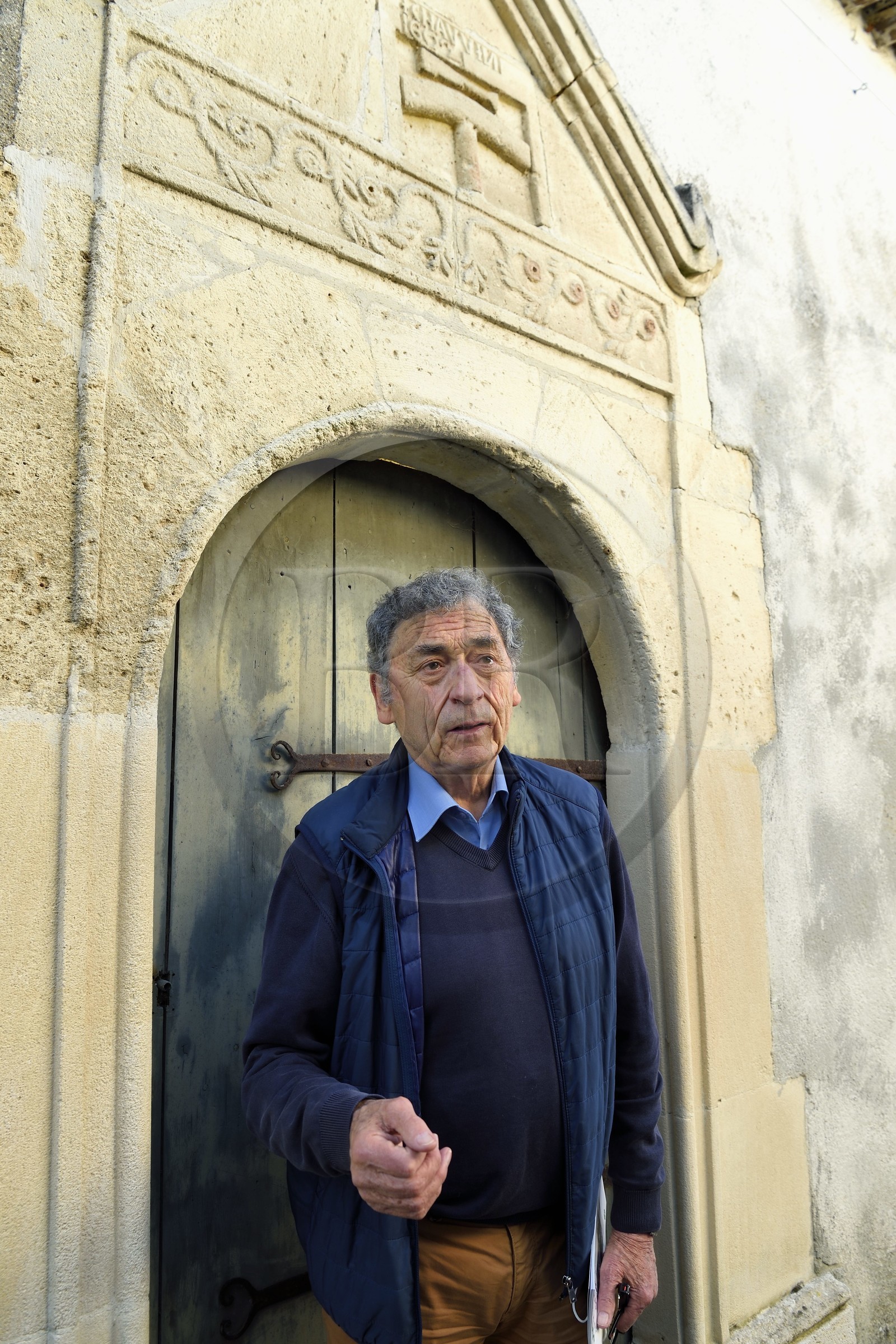 France, Charente, Saint Simon, the mayor of the gabarrier village Jean Jacques Delage in front of a door and sign of a craftsman caulker who participated in the construction of the barges (dated 1602), he filled the cracks of the boats with tow before covering them with pitch, resin and tar