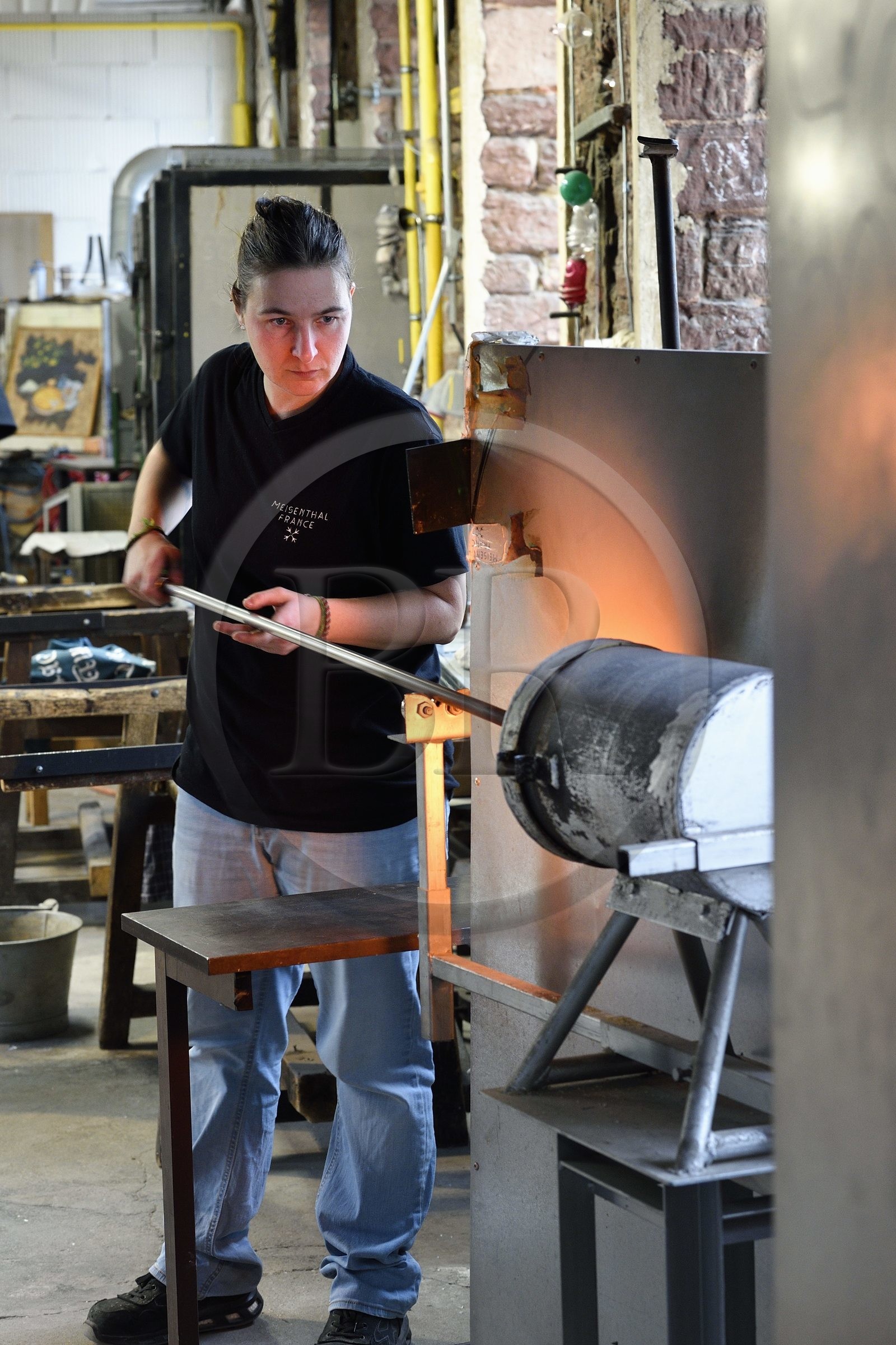 France, Moselle, Meisenthal, Centre international d'Art verrier (CIAV) (international glass centre), the blowing workshop, crafting a Christmas ball, the blower collects a mass of molten glass from the furnace, with his glassmaker's cane