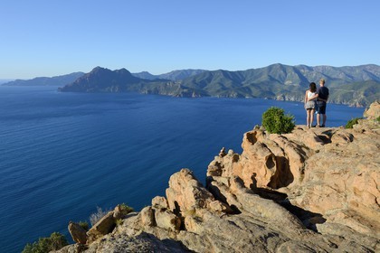 France, Corse du Sud, Golfe de Porto, listed as World Heritage by UNESCO, the Creeks of Piana (Calanches de Piana) with pink granite rocks, the Capo Senino and the Scandola peninsula Nature Reserve in the background