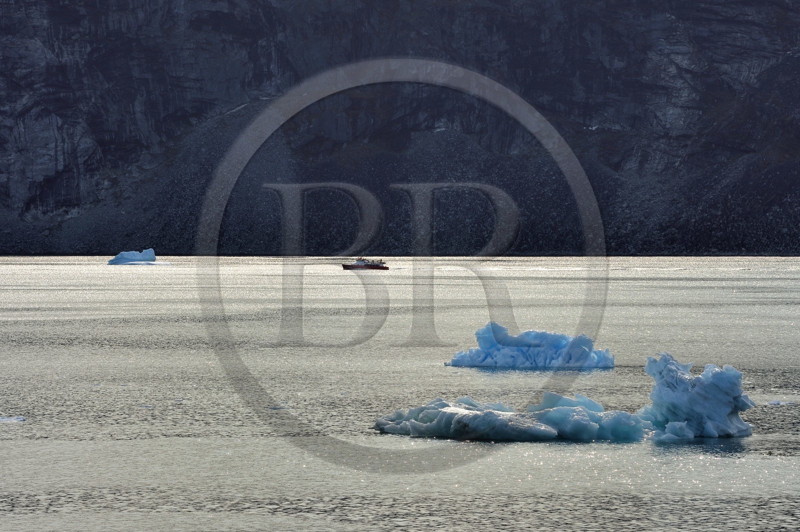 Greenland, west coast, Disko Bay, Ataa Strait, boat going up the strait of Ataa along the cliff
