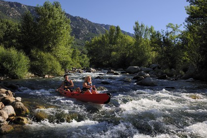 France, Herault, Orb valley, kayaking the river Orb at the moulin de Travassac next to Mons la Trivalle, the mount Caroux in the back