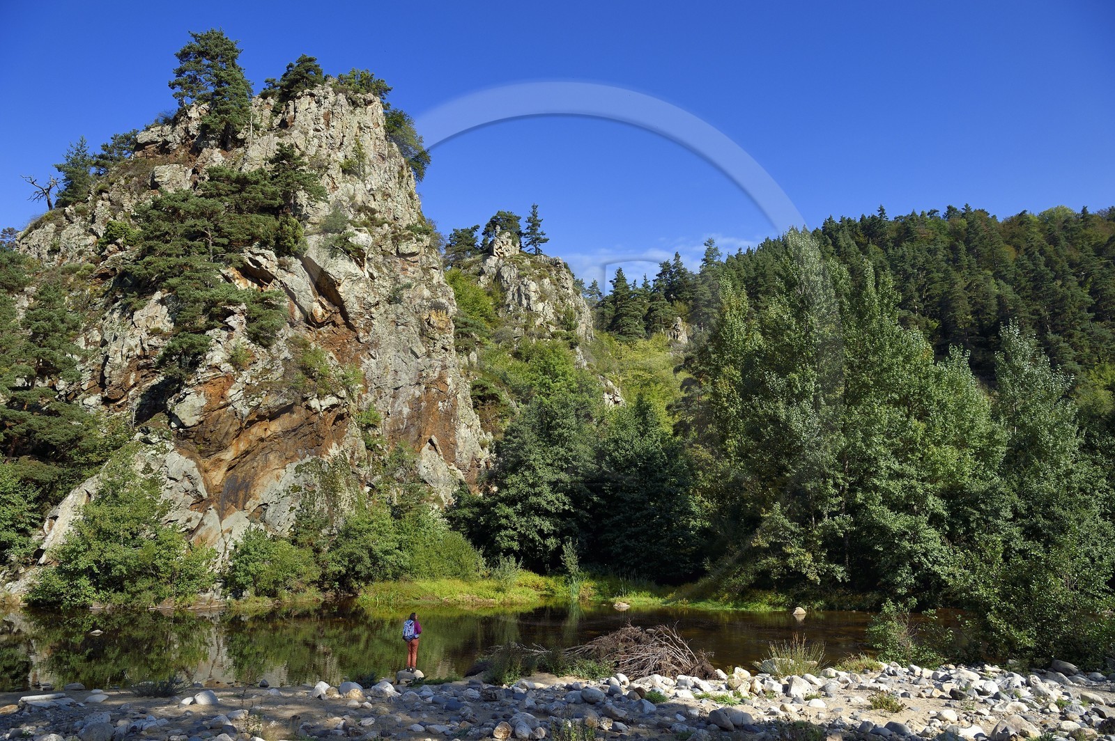 France, Haute Loire, Loire river Valley, Arlempdes, labelized the Most Beautiful Villages of France, hiker going up the gorges of the Loire river and its basaltic cliffs