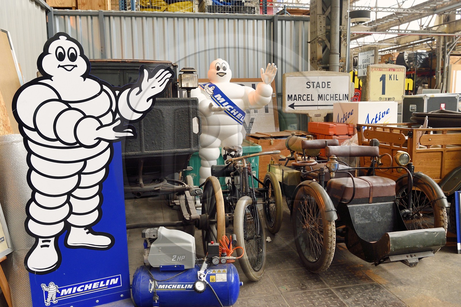 France, Puy-de-Dôme (63), Clermont-Ferrand, réserves du patrimoine historique dans l'usine Michelin de Cataroux, Bibendum, fiacre (1897), tricycle Deduon-Bouton (1896) et véhicule à trois roues tricycle Léon Bollée, tous équipés de pneumatiques Michelin