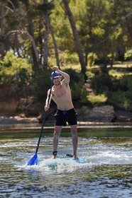 France, Var, Six Fours les Plages, Ile des Embiez, cape of Canoubié, Freestyle windsurfing champion Adrien Bosson on a paddle boarding excursion