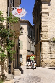 France, Gard, Uzes, bicycle taxi on a street in the old city