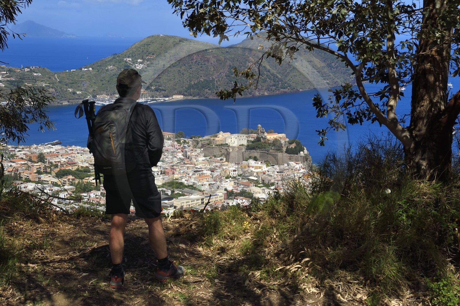 Italy, Sicily, Aeolian Islands, listed as World Heritage by UNESCO, Lipari Island, Lipari, hiker observing Lipari dominated by his citadel