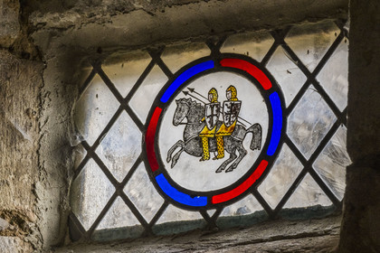 France, Aveyron, Causses and the Cévennes, cultural landscape of Mediterranean agro-pastoralism, listed as World Heritage by UNESCO, La Couvertoirade, labelled Les Plus Beaux Villages de France (The Most Beautiful Villages of France), fortified village on the Larzac plateau, stained glass window representing two riders on the same horse, theme of the order of the Temple