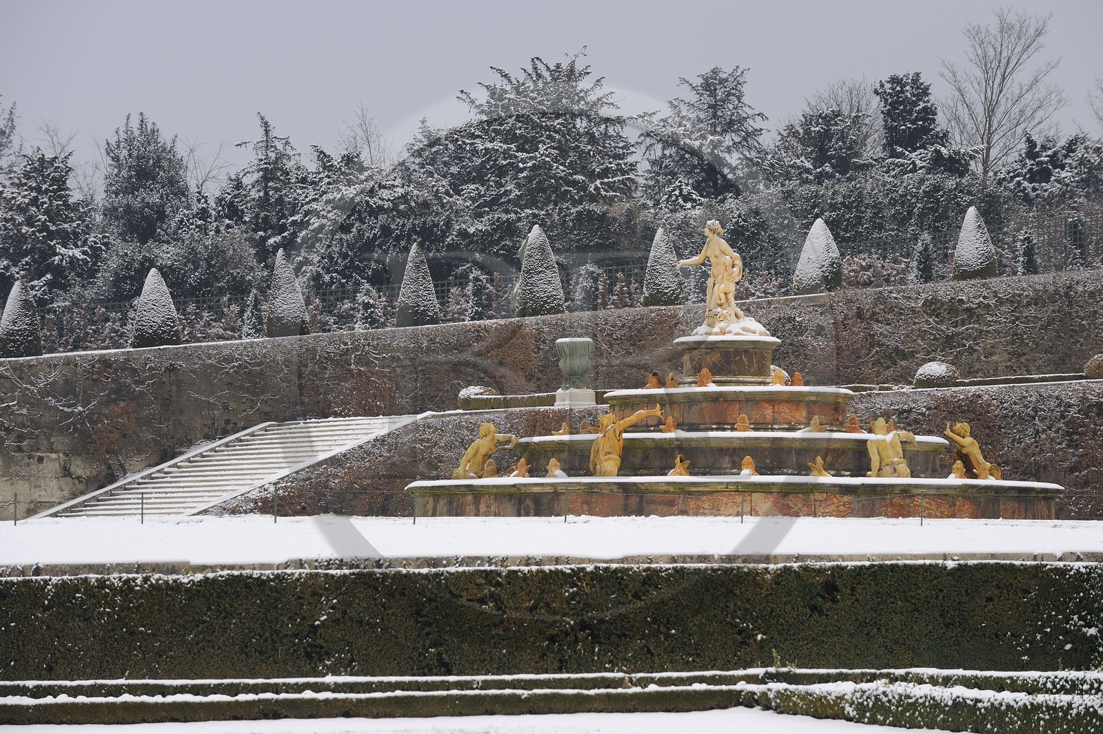 France, Yvelines, snow covered park of the Chateau de Versailles, listed as World Heritage by UNESCO, the Latona Basin