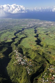 France, Reunion island (French overseas department), village Les Makes and the West coast towards St. Louis in the background (aerial view)