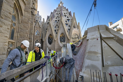 Spain, Catalonia, Barcelona, Eixample district, Sagrada Familia basilica by Catalan modernist architect Antoni Gaudi, listed as a UNESCO World Heritage Site, cloister construction site under the facade of the apse, the sacristy in the background