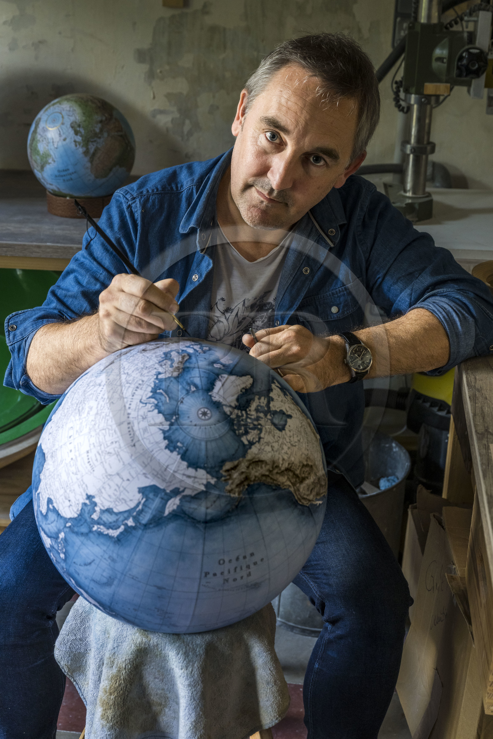 France, Charente, Cognac, Gabriel Gaborel, creator of OrbisTerrae, manufactures handcrafted terrestrial globes painted in watercolor