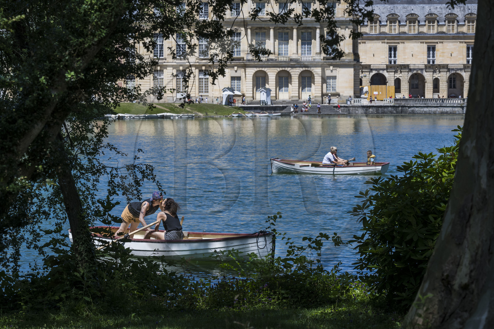 France, Seine-et-Marne, Fontainebleau, castle of Fontainebleau listed as World Heritage by UNESCO, lovers in a boat on the carp pond