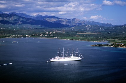France, Corse du Sud, Porto Vecchio, Club Mediterranée 2 cruise boat in the bay (aerial view)