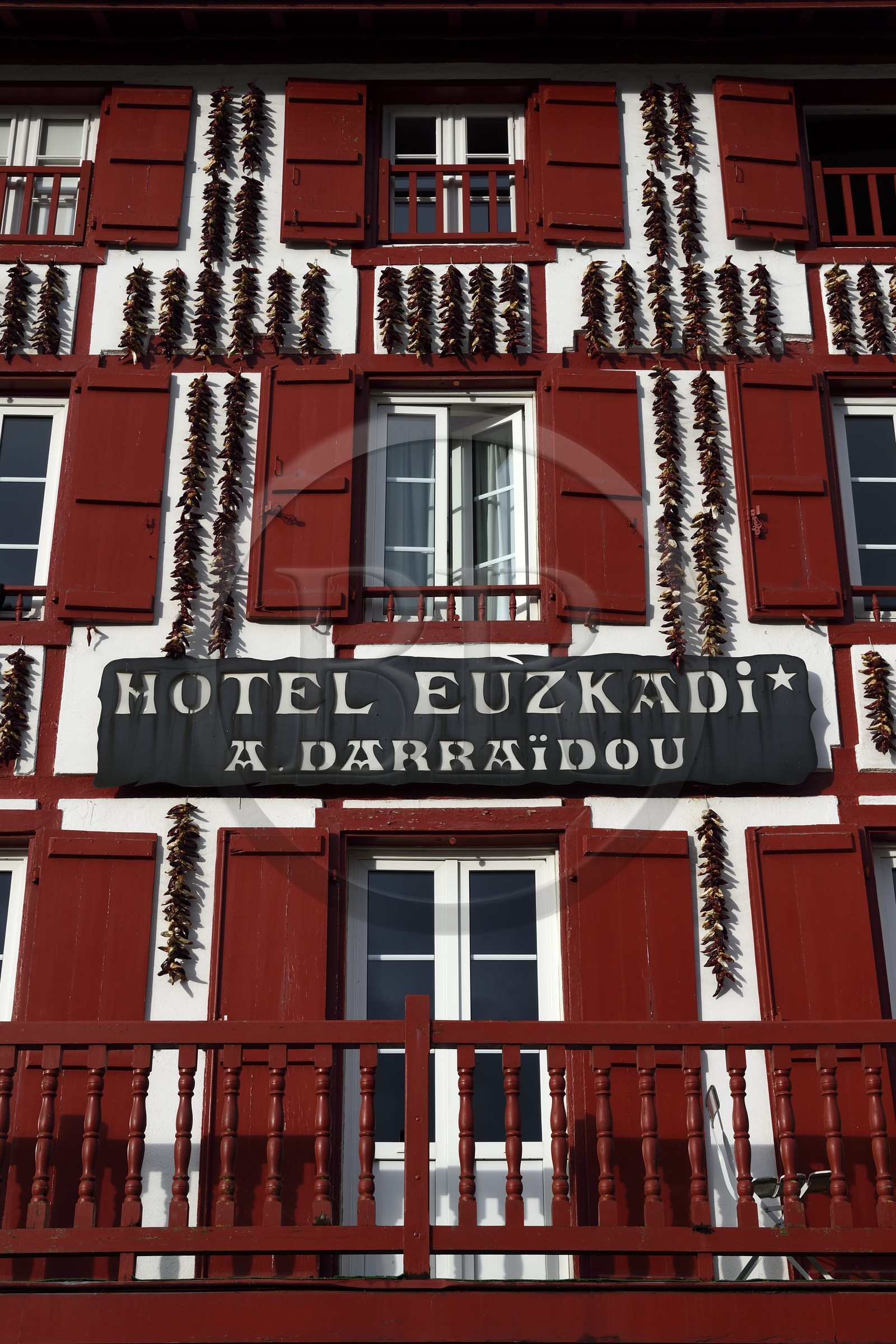 France, Pyrenees Atlantiques, Basque Country, Espelette, drying of Espelette peppers on the facades of village houses, the Euzkadi Hotel