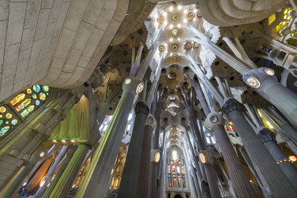 Spain, Catalonia, Barcelona, Eixample district, Sagrada Familia basilica by Catalan modernist architect Antoni Gaudi, listed as a UNESCO World Heritage Site, the transept and the interior of the Passion facade in the background