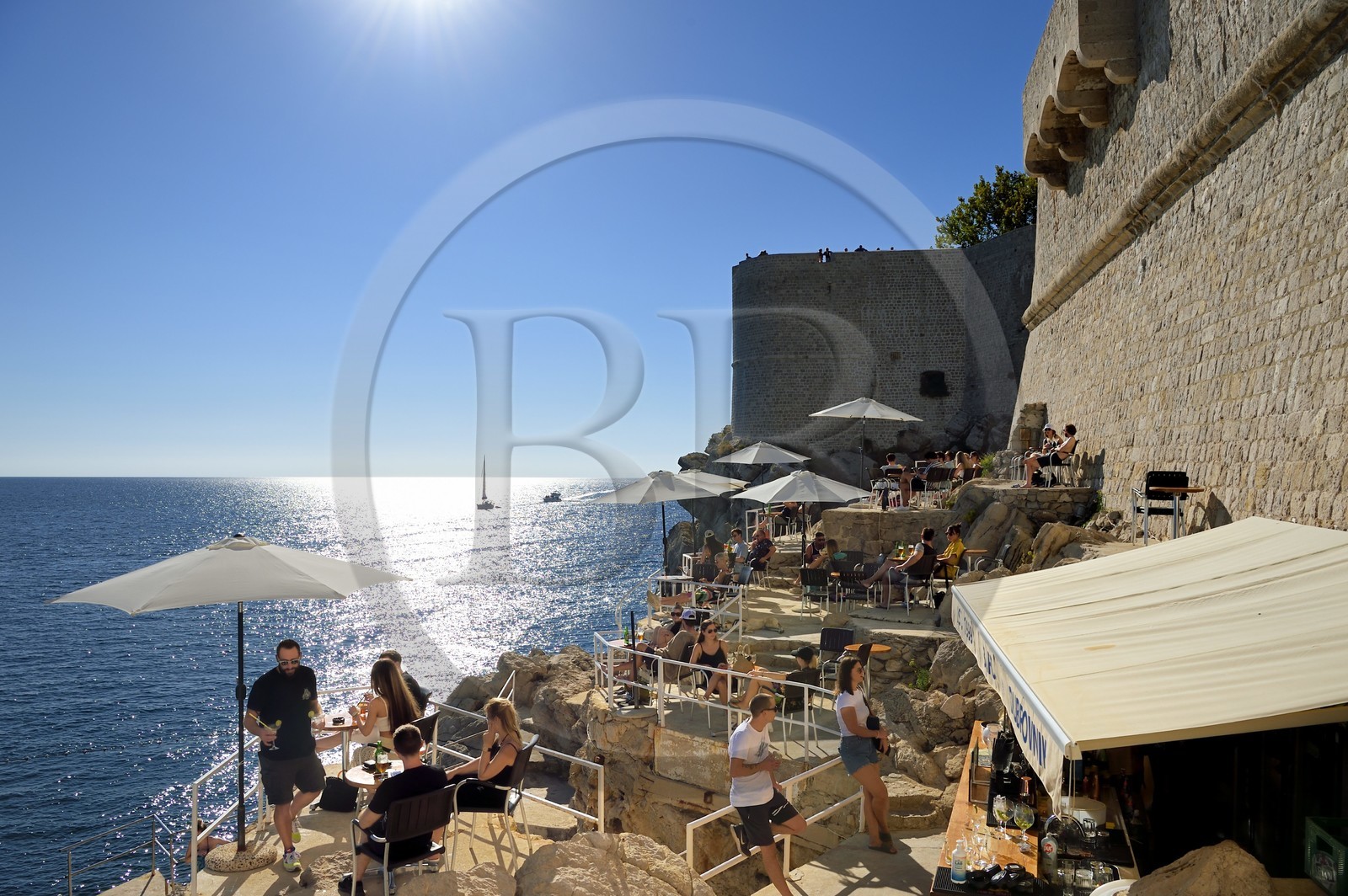 Croatie, Dalmatie, cote dalmate, Dubrovnik, centre historique classé Patrimoine Mondial de l'UNESCO, terrasse de café au pied des remparts coté mer