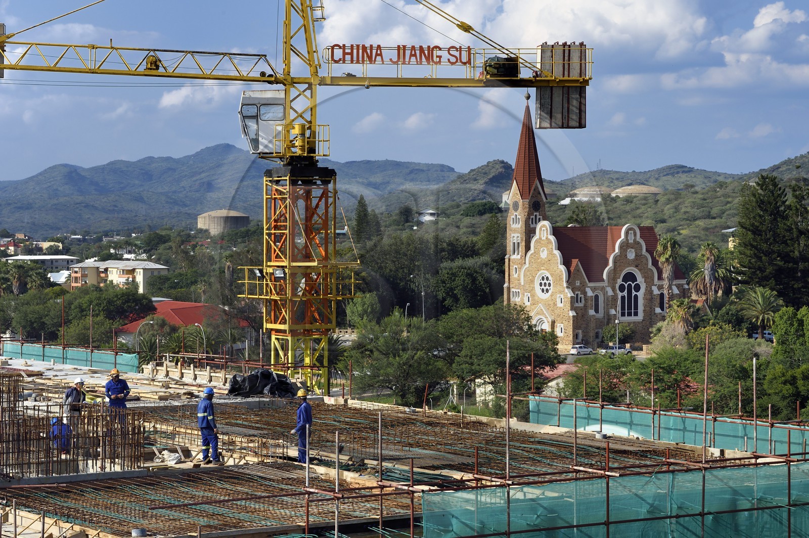 Namibia, Khomas region, Windhoek, building under construction by a Chinese company and the Christ Church (or Christuskirche) in the background