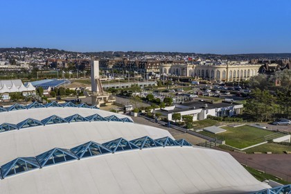France, Calvados, Pays d'Auge, Deauville, Olympic swimming pool by architect Roger Taillibert and the Casino Barriere de Deauville in the background
