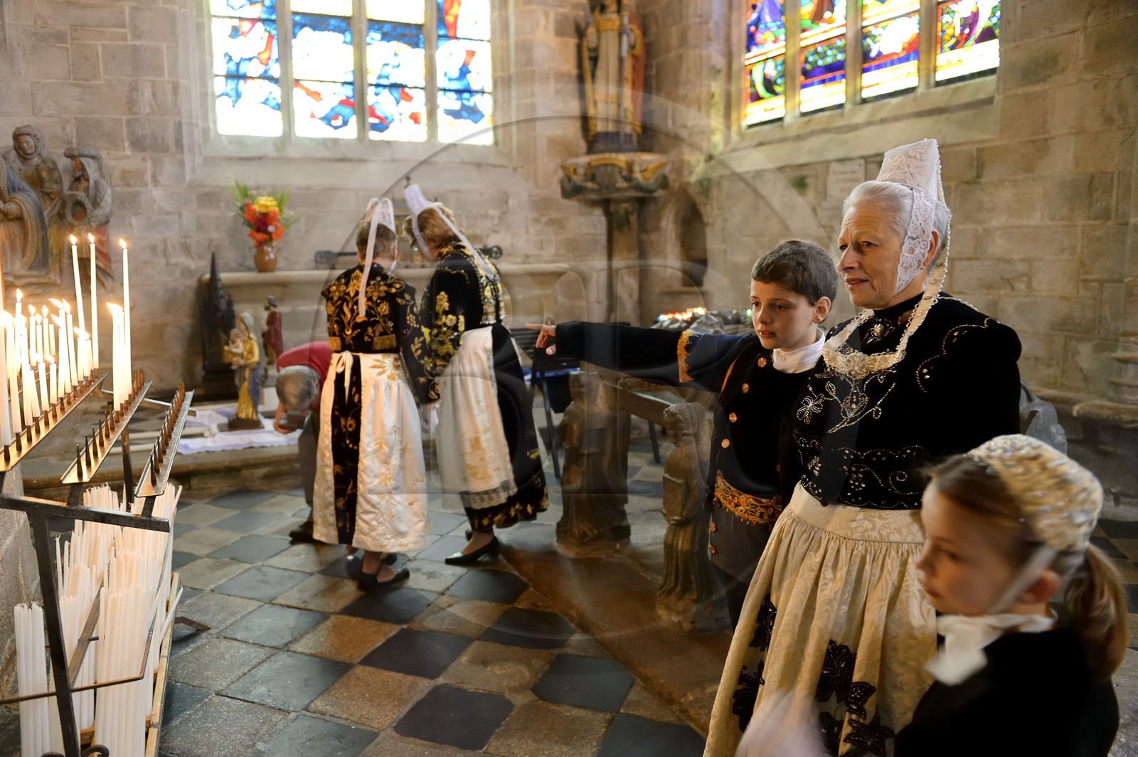 France, Finistere, Locronan, labelled Les plus Beaux Villages de France (The Most Beautiful Villages of France), women in traditional costume during the Tromenie around the cenotaph of St Ronan in Peniti chapel adjacent to the Saint Ronan church