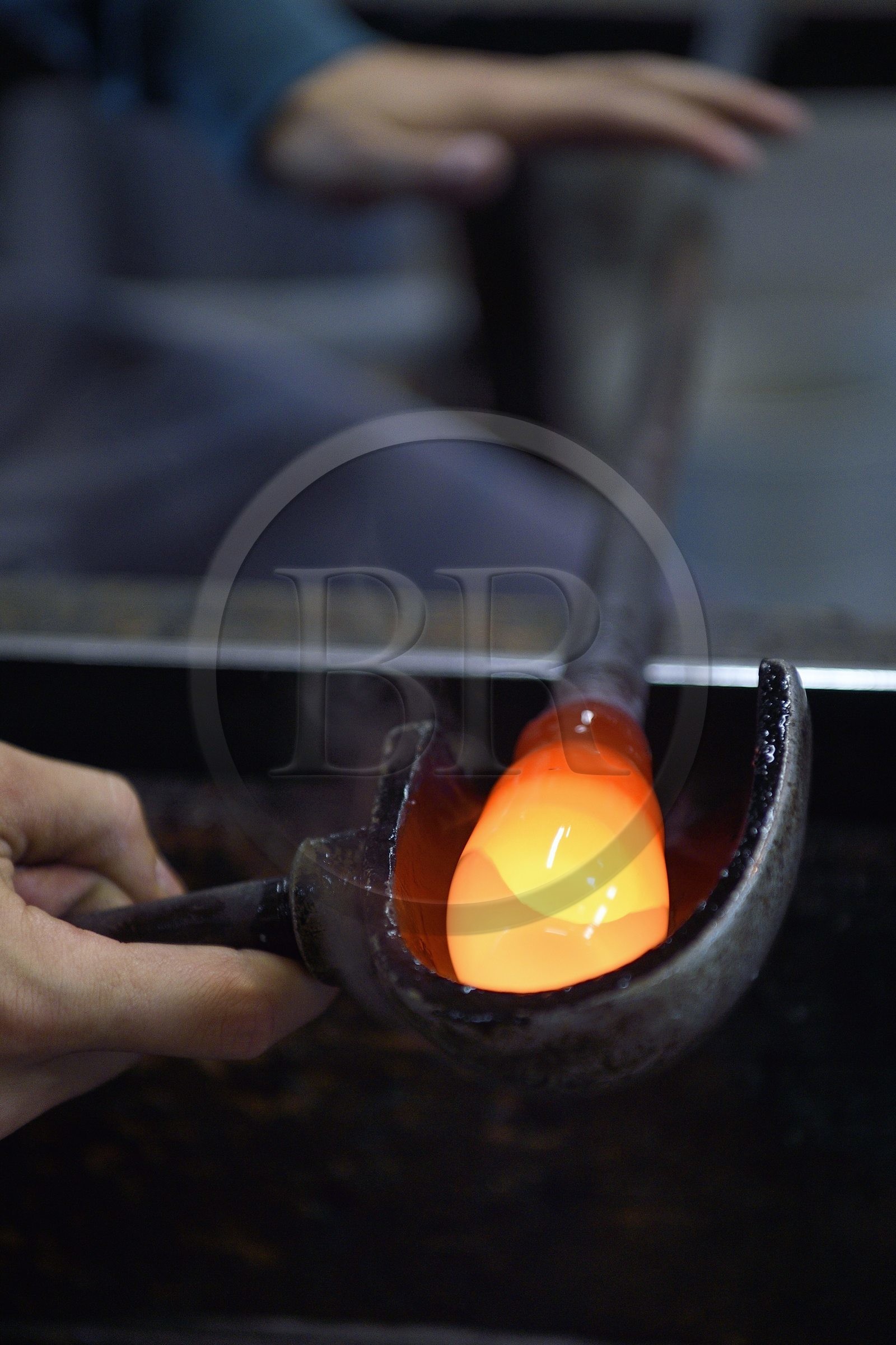 France, Moselle, Meisenthal, Centre international d'Art verrier (CIAV) (international glass centre), the blowing workshop, crafting a Christmas ball, the prompter regulates the mass at home plate while performing a continuous rotation of his cane