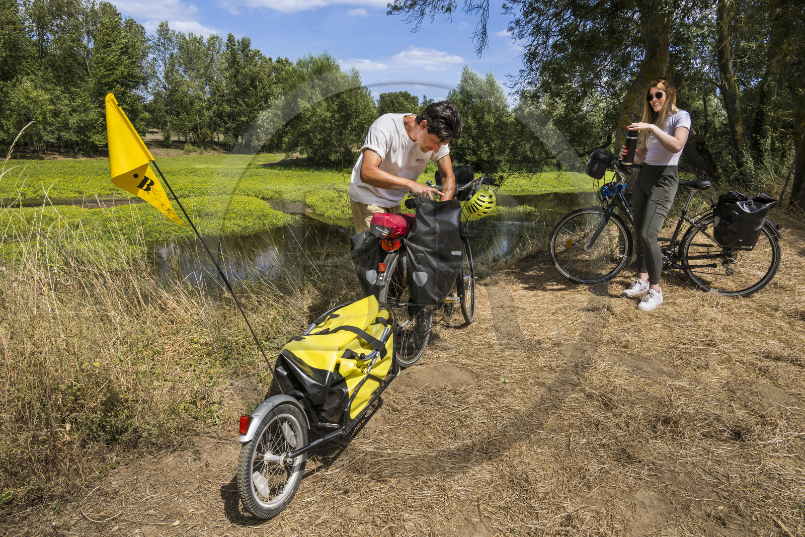 France, Maine-et-Loire, Loire valley listed as World Heritage by UNESCO, Dampierre to the east of Saumur, cycling along the banks of the Loire on the Loire à Vélo cycle path, bike with a trailer carrying camping equipment