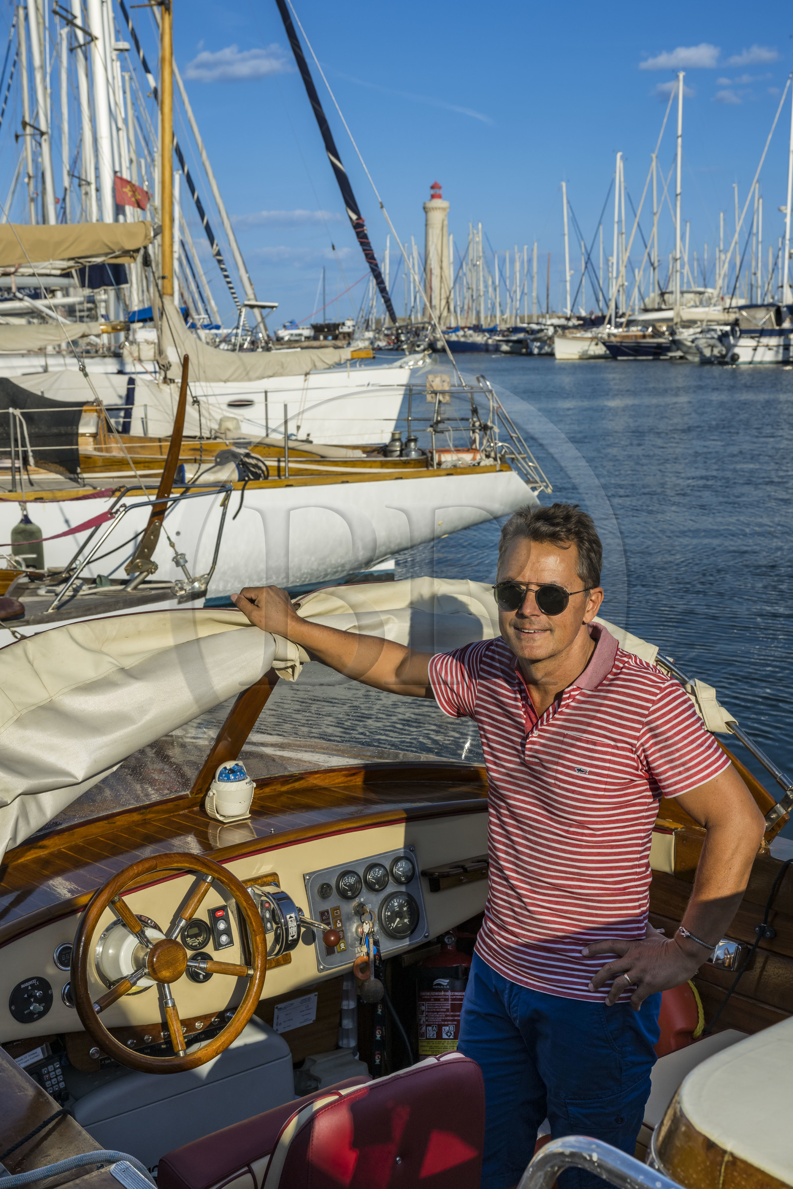 France, Herault, Sète, the marina and the lighthouse of the Mole Saint-Louis, Jean Christophe Lucien Gay, captain of the boat Sant'Helena offers a discovery of the city through its canals