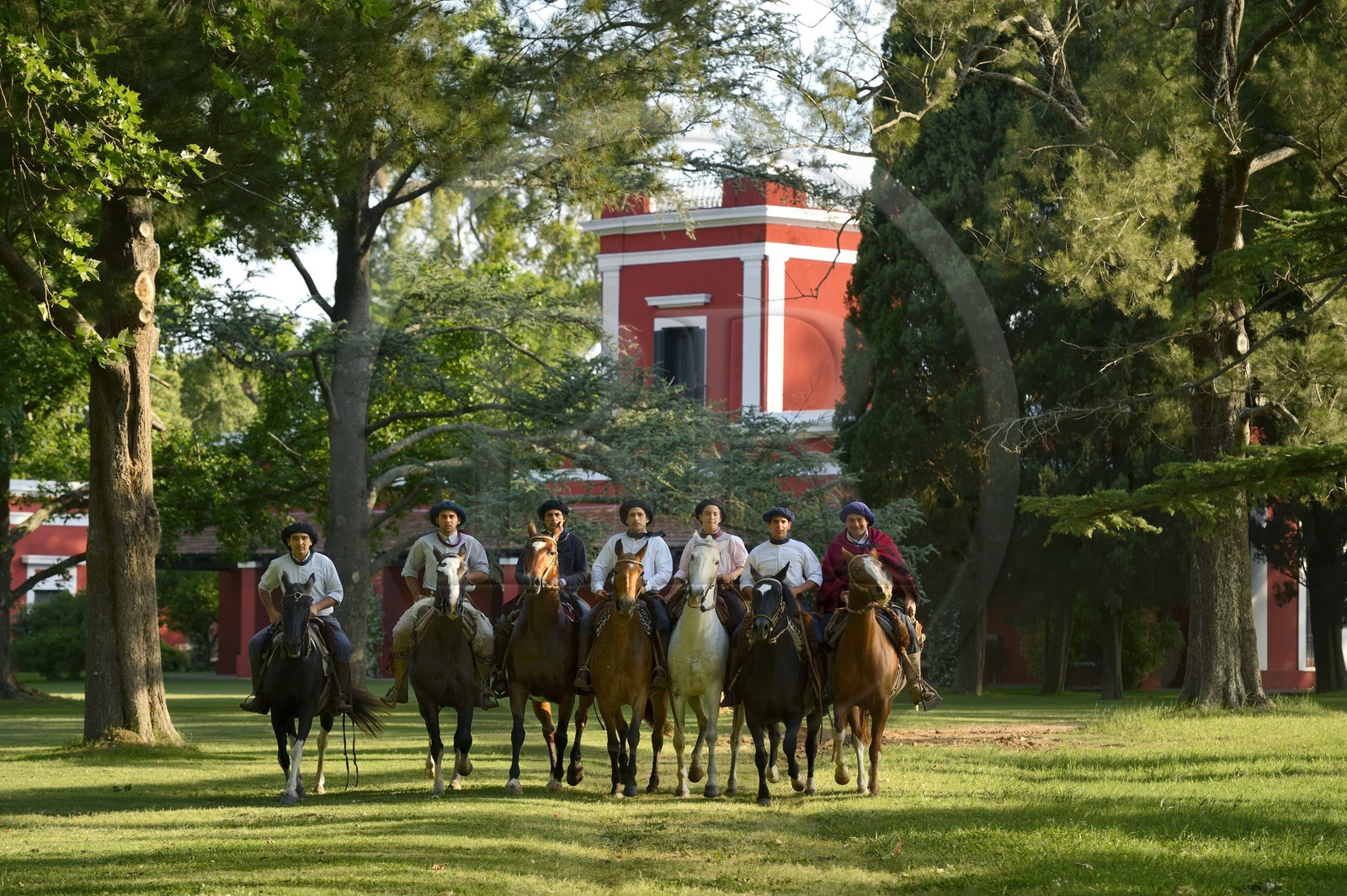 Argentina, Buenos Aires Province, San Antonio de Areco, group of gauchos on horseback in front of the estancia La Bamba de Areco