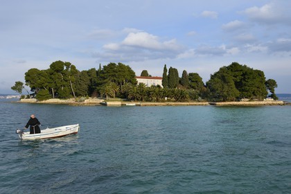 Croatia, Dalmatia, Dalmatian Coast, Ugljan Island, Preko, Franciscan friar Bozo Susic rejoining the Franciscan Monastery of the Galovac island on his boat