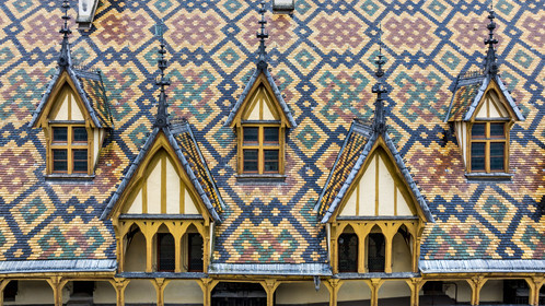 France, Cote d'Or, Beaune, area listed as World Heritage by UNESCO, Hospices de Beaune, Hotel Dieu, the roofs covered with glazed and colored tiles (aerial view)