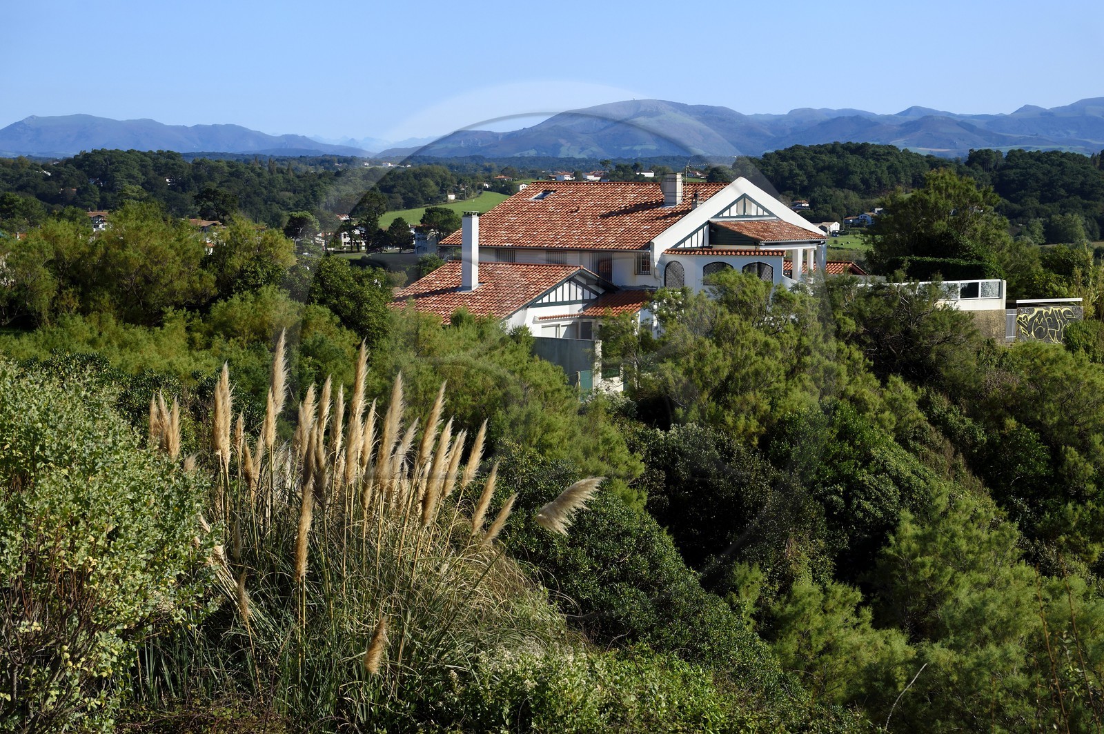 France, Pyrenees Atlantiques, Basque Country coast, Bidart, traditional neobasque style house and the Pyrenees in the background