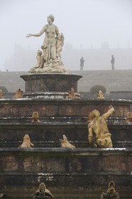 France, Yvelines (78), parc du château de Versailles, classé Patrimoine Mondial de l'UNESCO, statue de le Bassin de Latone dans la brume hivernale