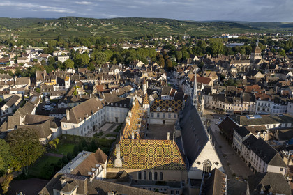 France, Cote d'Or, Beaune, area listed as World Heritage by UNESCO, Hospices de Beaune, Hotel Dieu, the Notre-Dame de Beaune collegiate basilica and the Côte de Beaune in the background (aerial view)