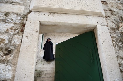 Croatia, Dalmatia, Dalmatian Coast, Sibenik, Convent of St. Lucia (samostan sv. Luce), nun on the phone coming to the main gate, Sister Fortunata