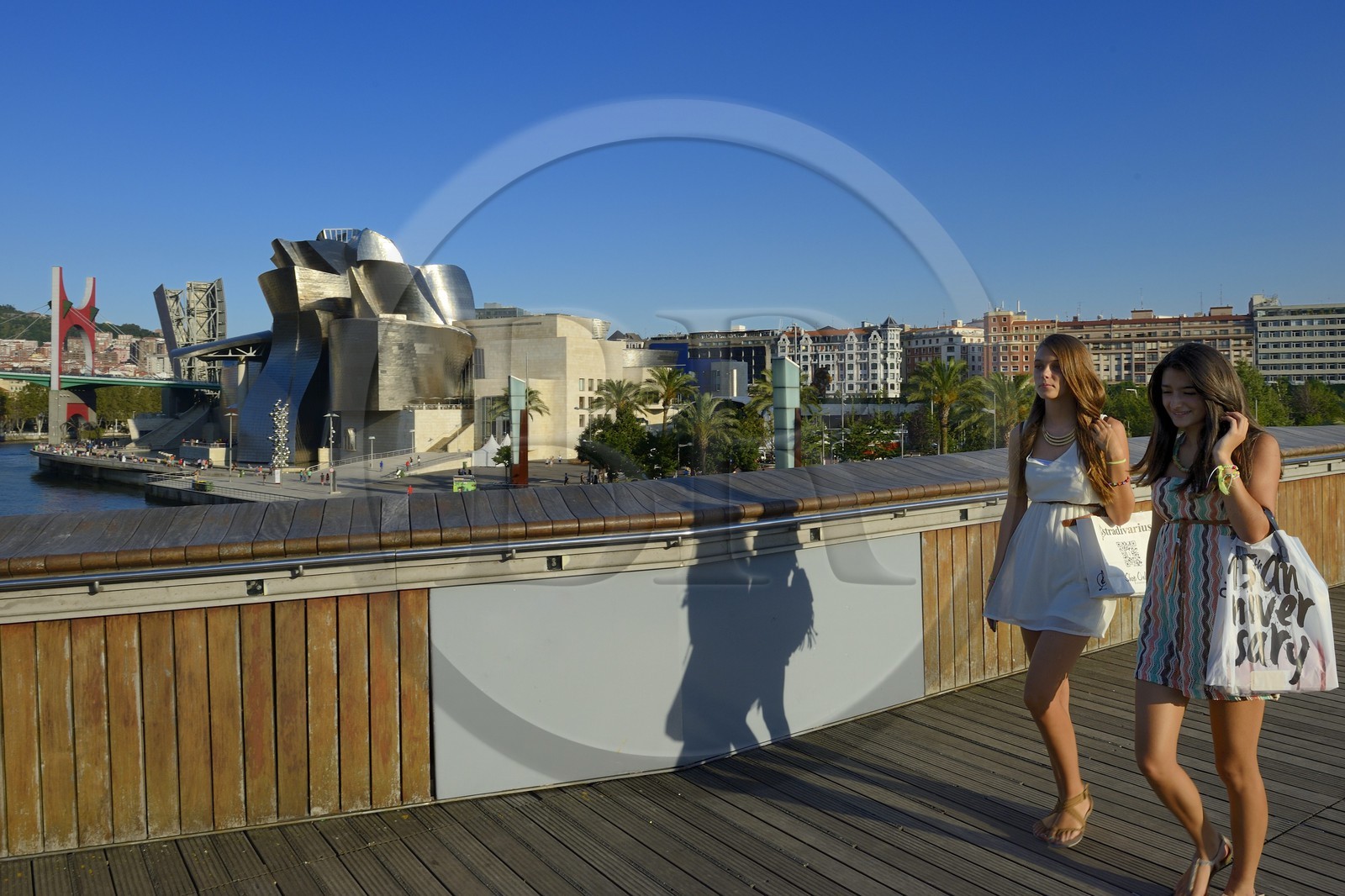 Spain, Basque Country Region, Vizcaya Province, Bilbao, the Guggenheim Museum designed by Frank Gehry seen from Pedro Arrupe footbridge by architect Jose Antonio Fernandez Ordonez, over the Nervion river