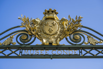 France, Oise, Chantilly, the castle of Chantilly and the Condé museum, gate of honor with royal emblems (the fleur-de-lis)