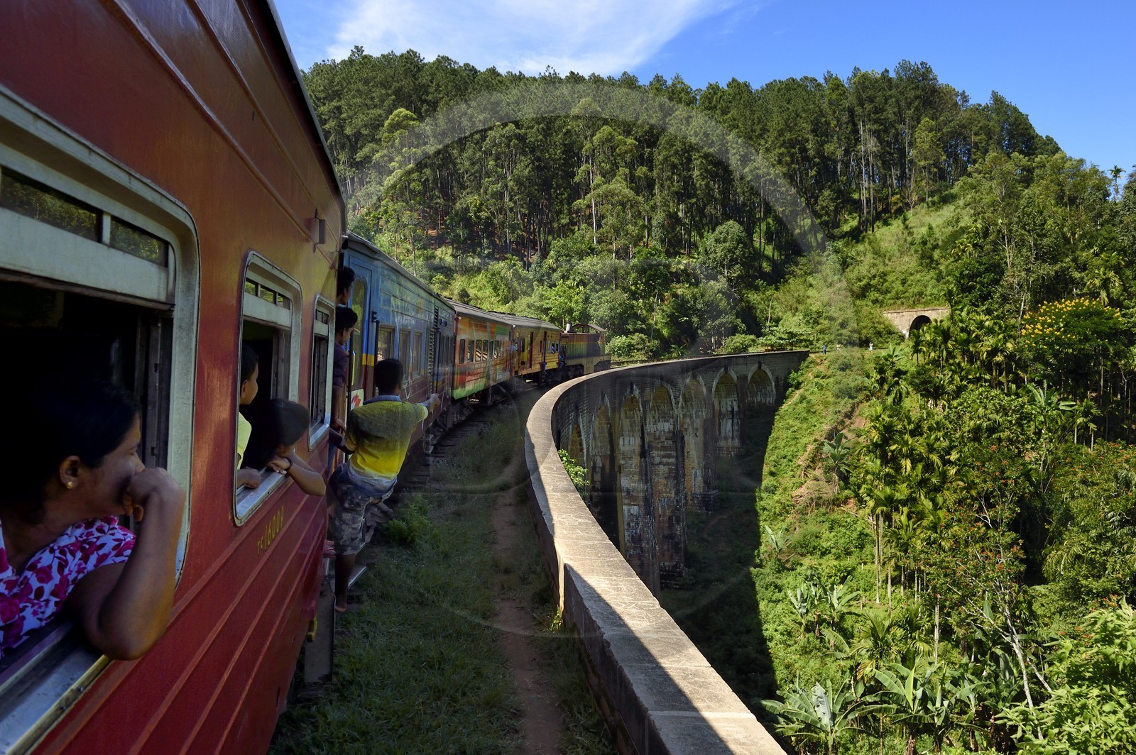 Sri Lanka, Province d'Uva, train sur la voie de chemin de fer dans la région montagneuse de la culture du thé entre Badulla et Ella, le Pont aux Neuf Arches non loin de Ella, passagers accrochés aux portières
