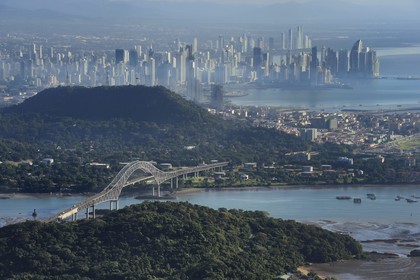 Panama, Panama City, the waterfront skyscrapers and the Bridge of the Americas (Puente de las Americas) on the access channel of the Panama Canal in the foreground (aerial view)