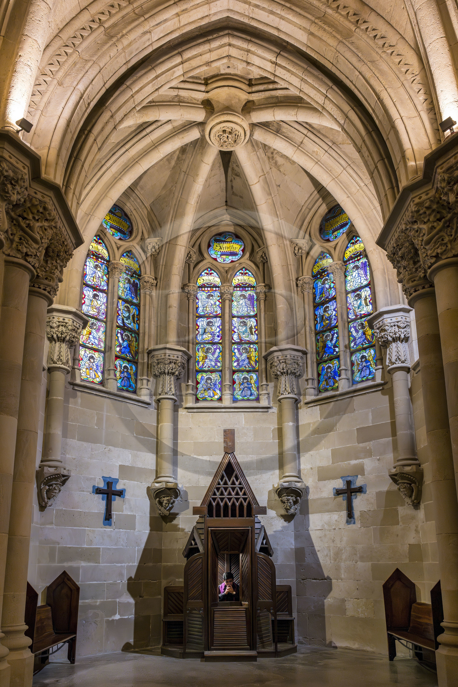Spain, Catalonia, Barcelona, Eixample district, Sagrada Familia basilica by Catalan modernist architect Antoni Gaudi, listed as a UNESCO World Heritage Site, the neo-Gothic style crypt serves as a parish church, furniture and liturgical objects designed by Gaudi, priest Joby Sebastian Kappiparambil in the confessional