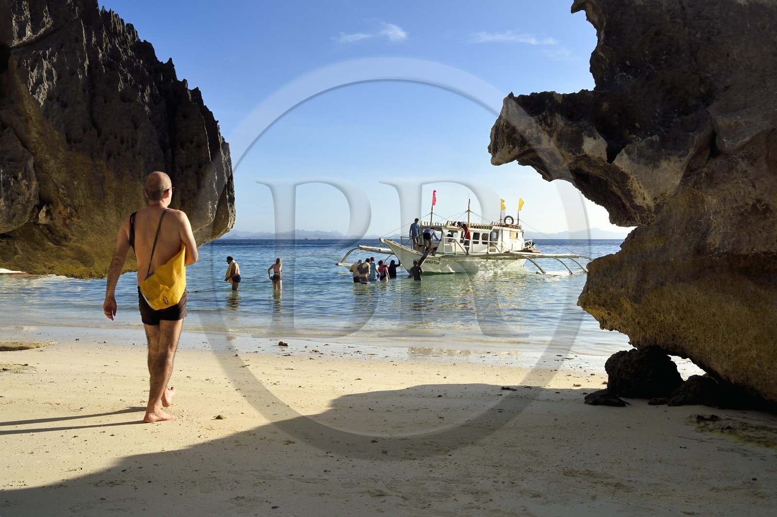 Philippines, Calamian Islands in northern Palawan, Coron Island Natural Biotic Area, Banul Beach, embarking on an outrigger canoe