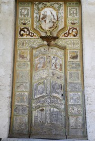 France, Haute Corse, Castagniccia, village of Piazzole d'Orezza, Church of the Annunciation, the tradition reported that a repentant bandit carved on the door of the church several biblical scenes (the announcement to Mary, David and Goliath) and a beautiful scenery of vineyards and wheat