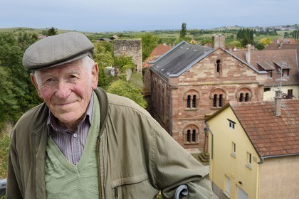 France, Bas Rhin, Westhoffen, Roger Cahn, the last Jew of Westhoffen born in 1930, the former synagogue in the background