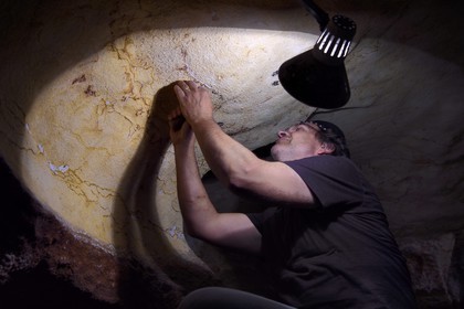 France, Dordogne, Montignac, Montignac-Lascaux Parietal Art international Centre (Lascaux 4) building site, finishing work by artistic and production director Francis Ringenbach in the passage of the reconstituted cave by the Atelier des Fac-Similés du Périgord (Perigord's Facsimile Workshop AFSP)