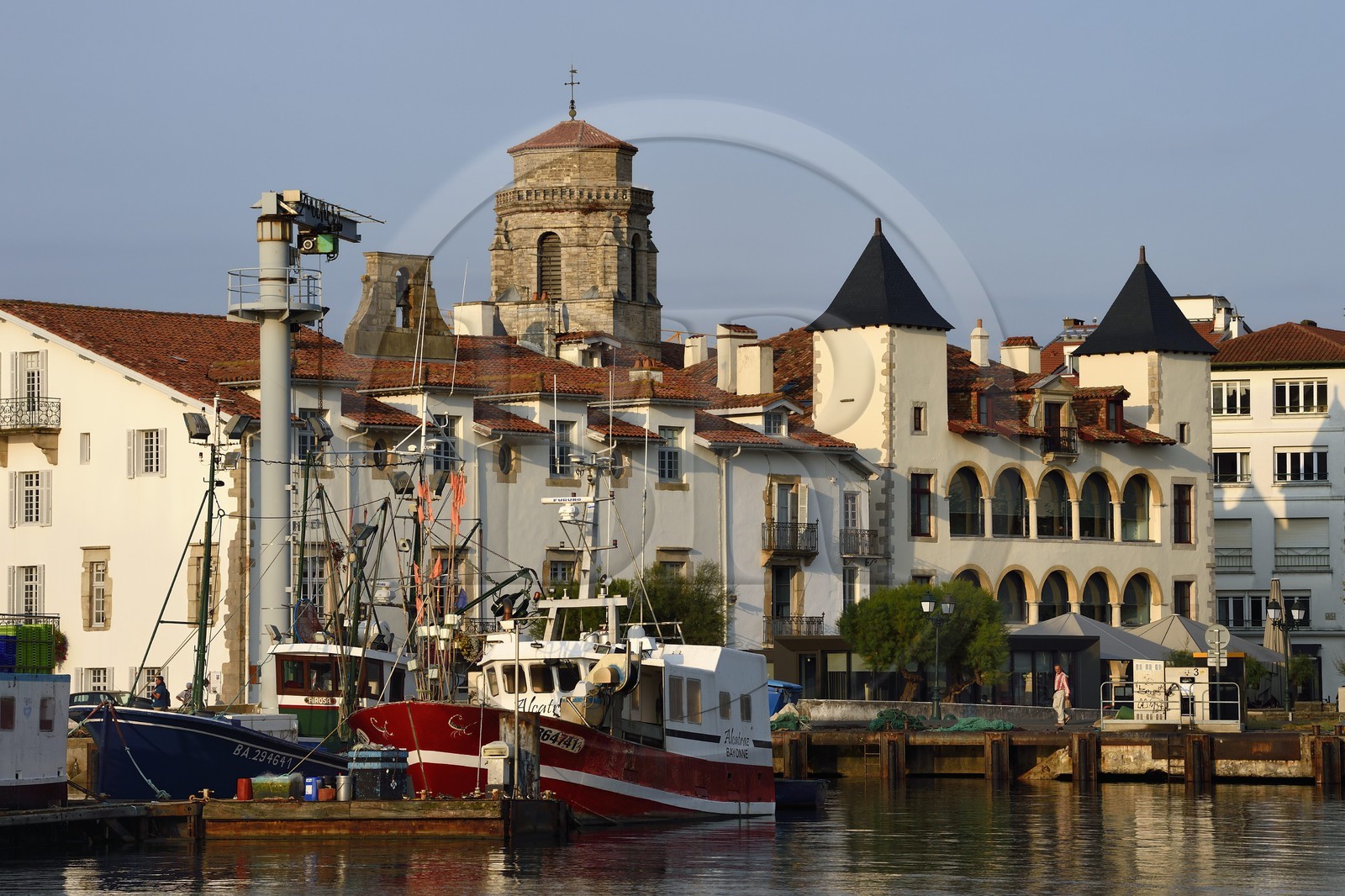France, Pyrenees Atlantiques, Basque Country, Saint Jean de Luz, the fishing port, the white facade of the town hall, the house of Louis XIV on the right and the Saint-Jean-Baptiste (Saint John the Baptist) Church