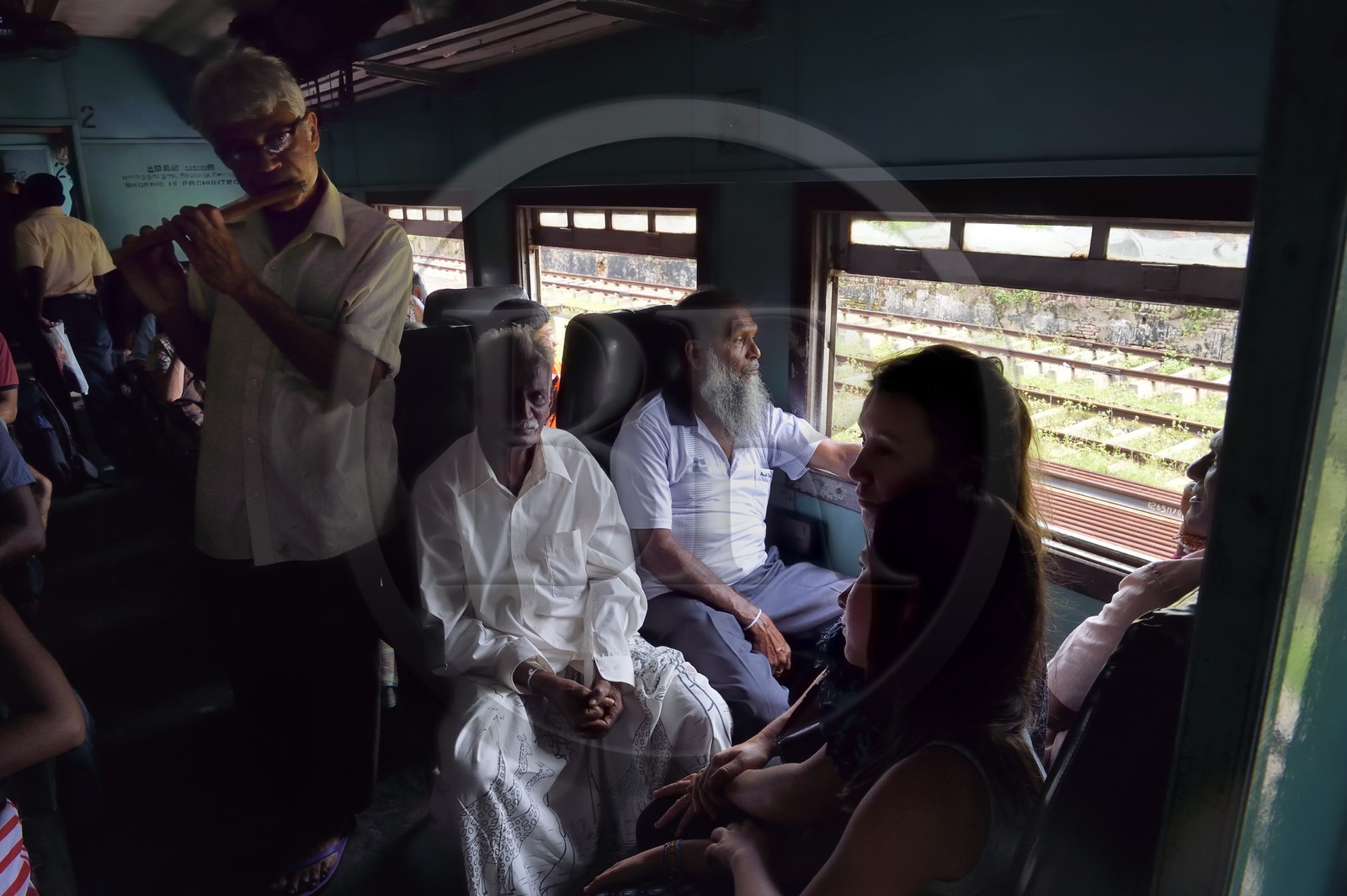 Sri Lanka, Southern Province, train from Galle to Colombo, a flutist accompanies the travelers