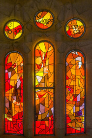 Spain, Catalonia, Barcelona, Eixample district, Sagrada Familia basilica by Catalan modernist architect Antoni Gaudi, listed as a UNESCO World Heritage Site, lower stained-glass windows in the naves representing the saints and shrines of local churches by the Catalan painter and stained glass artist Joan Vila-Grau