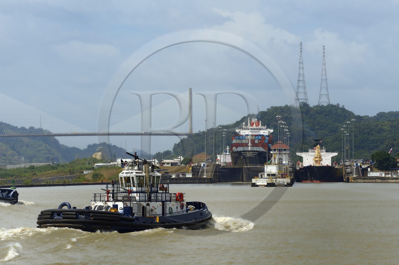 Panama, Panama Canal, Pedro Miguel locks, Panamax cargo passing the lock and tugboat